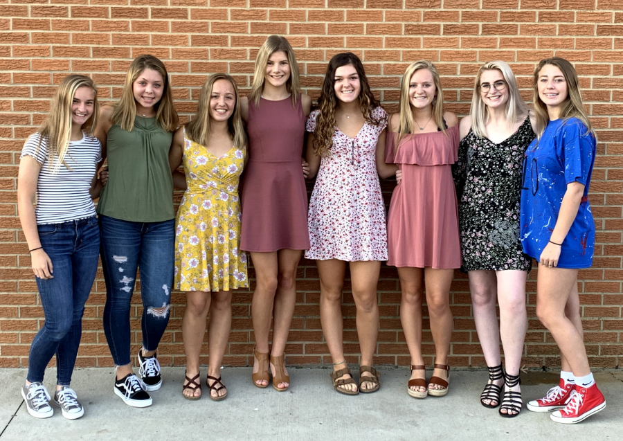 girls along a brick wall